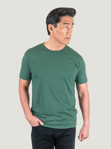 Phil is 6'1, 185lbs and wears a size M # Pine Green Crew Neck Studio Size Medium | Fresh Clean Threads