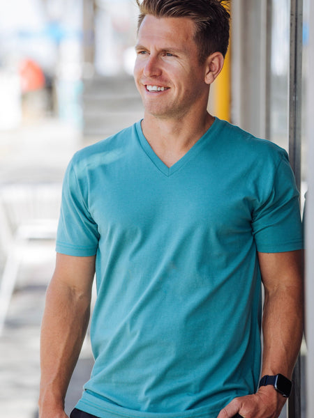 Brad is 5'9", 170LBS and wears a size M # Vintage Blue V-Neck Tee Lifestyle Model Size M | Fresh Clean Threads