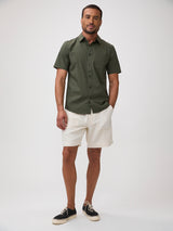 man wearing an Army green shirt bold character on a shirt built for hard use