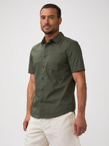 Man wearing an army green short-sleeve shirt | Pairs with denim, khaki, and earth tones without effort