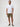 Man wearing a white short-sleeve shirt and green shorts | FCT makes better basics