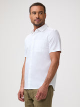 Man wearing a white short-sleeve shirt | stretch fabric, forgiving fit, and all-day comfort with no trade-offs