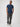 Man wearing a blue t-shirt and gray jeans on a white background