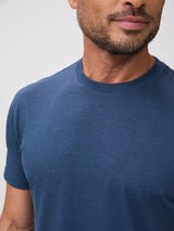 Man wearing a blue t-shirt against a plain background