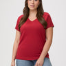 Laurel is 5'7" and wears a size M # Woman wearing a chili red t-shirt and blue jeans | great v-neck tees for everyday 