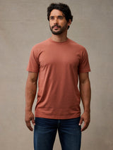 Man wearing copper rust colored crew neck t-shirt