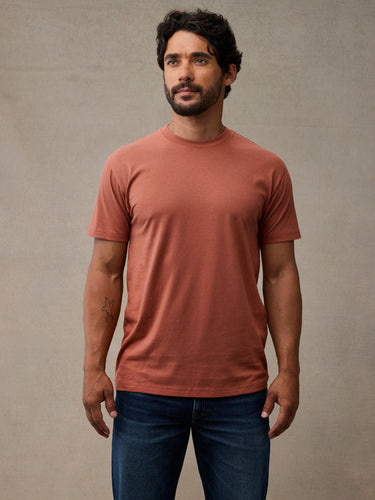 Man wearing copper rust colored crew neck t-shirt