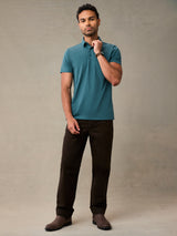Man wearing casual teal polo shirt, with a structured collar that holds wash after wash