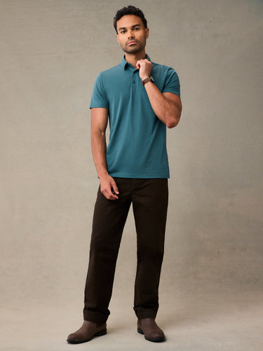 Man wearing casual teal polo shirt, with a structured collar that holds wash after wash