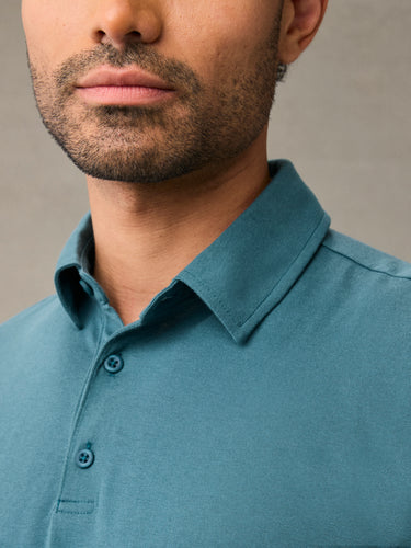 Close-up of breathable cotton poly fabric weave on teal polo shirt