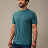 Man wearing teal blue crew neck t-shirt made from StratuSoft™ cotton poly blend
