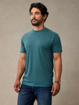 Man wearing teal blue crew neck t-shirt made from StratuSoft™ cotton poly blend