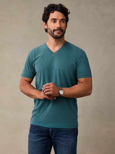 Man wearing a teal blue v-neck t-shirt. the best v-neck tee for layering.