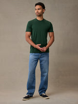 man in muted green crew neck built for outdoor comfort