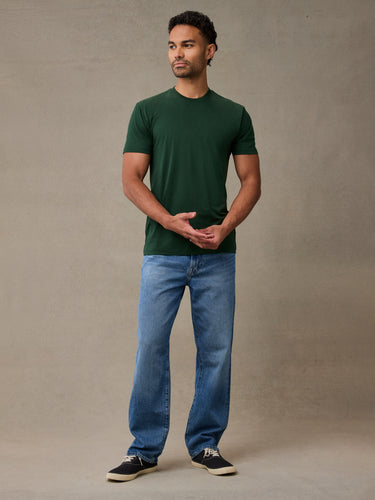 man in muted green crew neck built for outdoor comfort