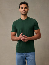 Man wearing muted moss green crew neck t-shirt, best fit