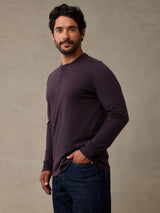 Man wearing deep mulberry colored henley long sleeve shirt