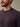 Close-up of button placket detail on mulberry colored henley shirt