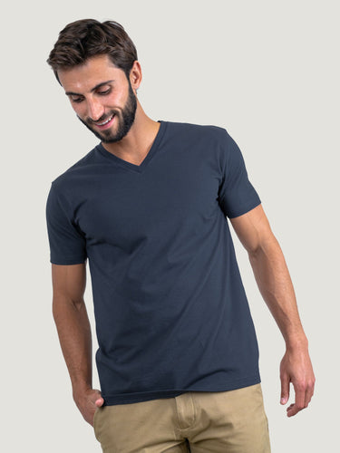 Pasha is 6' 180 lbs and wears a size M # Odyssey Blue V-Neck Size Medium in Studio | Fresh Clean Threads