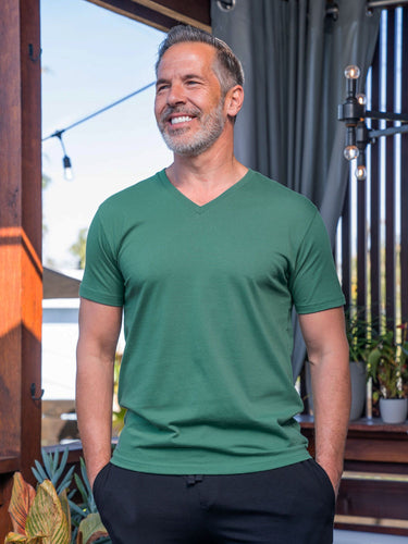 Jamie is 6'2, 200lbs and wears a size M # Pine Green V-Neck Lifestyle Size Medium | Fresh Clean Threads