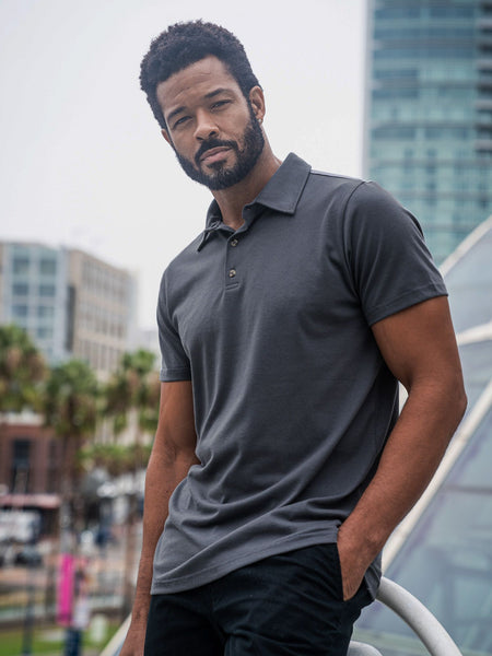 Jarrett is 6', 168lbs and wears a size M # Graphite Torrey Polo Lifestyle Size Medium | Fresh Clean Threads